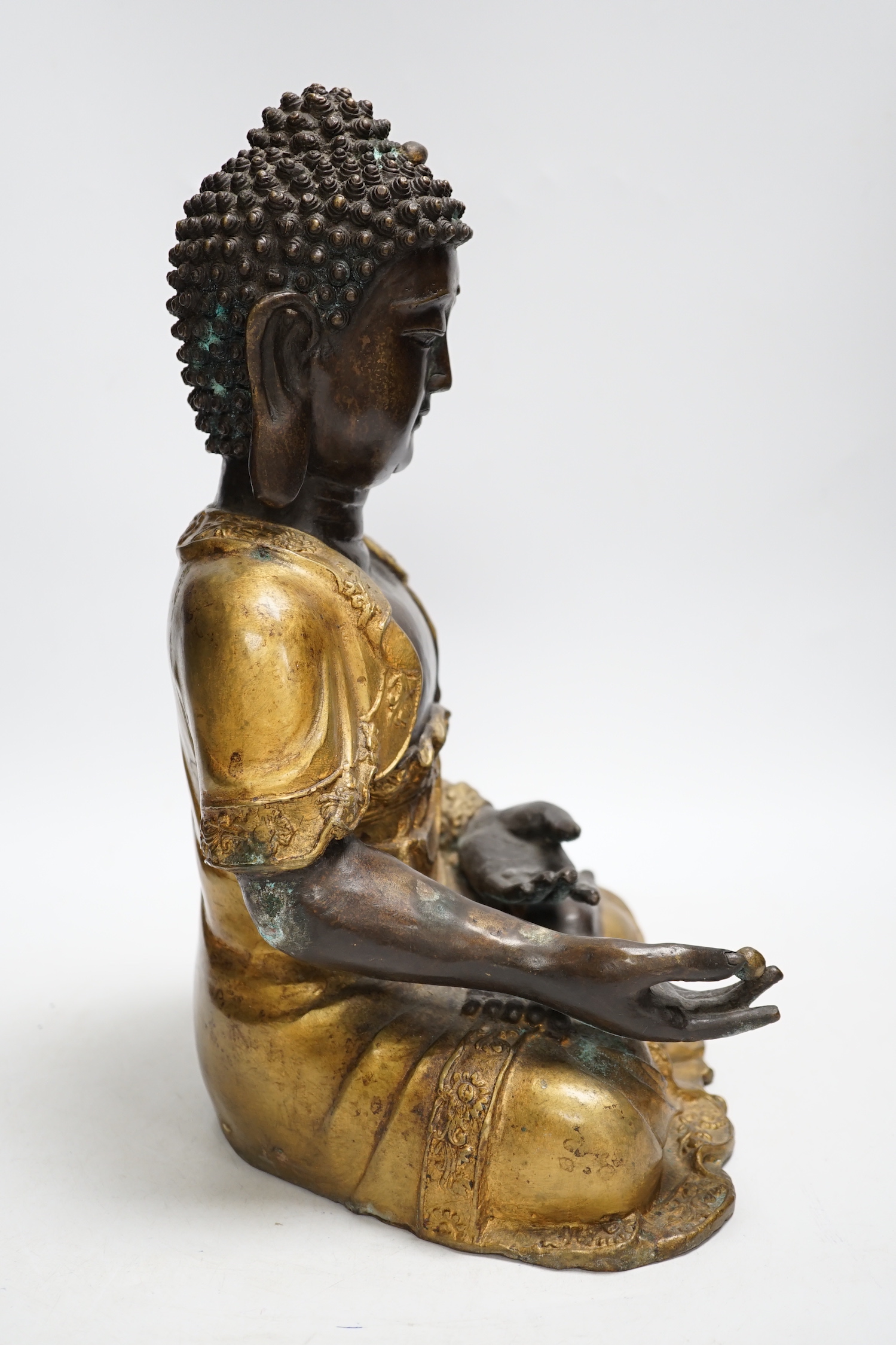 A gilt bronze seated Buddha, 35cm high